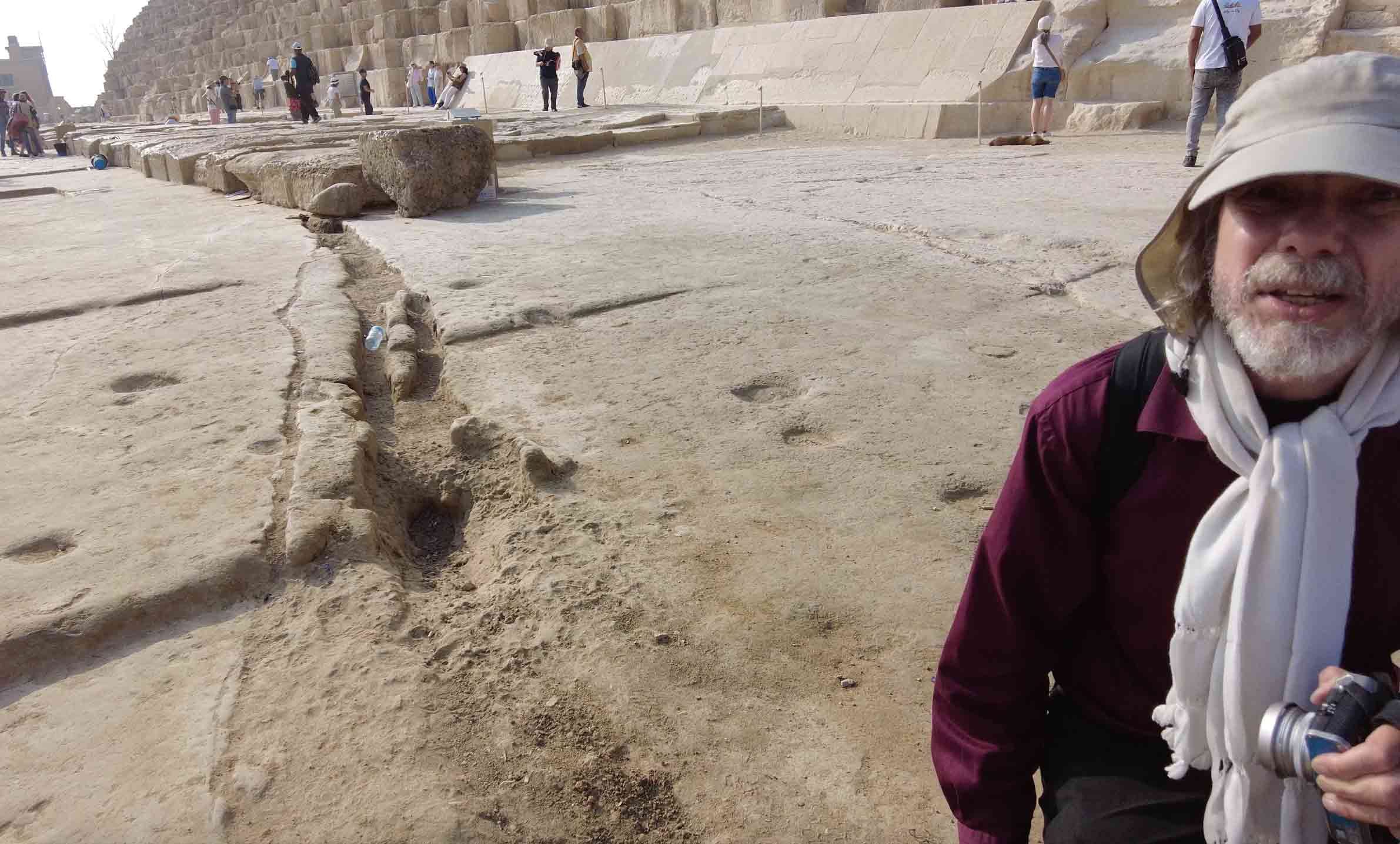 Image of Robert Schoch beside the remnants of a large Lichtenberg channel emanating from 
				the north side of the Great Pyramid