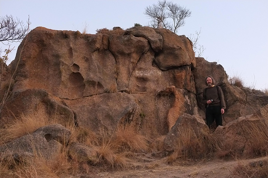 Overview image of Robert Schoch standing near the granite footprint. Also visible 
					is an erosional feature that resembles a snowman.